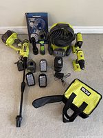 All items laid out: batteries, chargers, drills, fan, power washer with wand, flashlight, accessory kit, bag