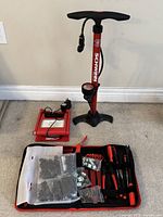 Full view of Schwinn floor pump, electric pump and open repair tool kit