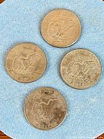 Reverse sides showing eagle on Moon, four coins