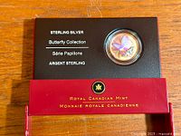 Coin in presentation tray showing text Sterling Silver Butterfly Collection