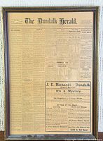 Full view of framed antique newspaper