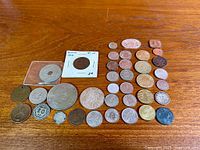 All coins and tokens spread on wood surface