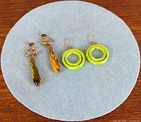 Both earring pairs displayed on felt circle