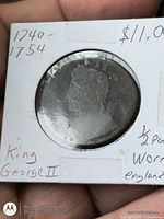Obverse of King George II half penny in 2x2 holder showing worn bust