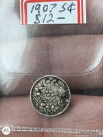 Reverse view of 1907 Canada 5-cent coin in holder