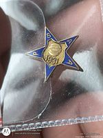 Front view of star shaped blue enamel basketball award pin dated 1931