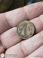 Reverse side of 1943 Canada 5-cent coin showing torch, maple leaves, denomination, year
