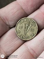 Reverse of 1943 Canada 5-cent coin showing V-torch design