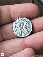 Reverse side showing torch and V design, 1945 date and denomination