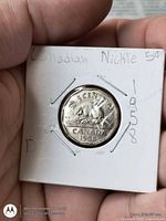 Reverse of 1958 Canadian 5-cent coin in cardboard flip showing beaver design and date