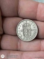 Reverse of 1963 one shilling showing crowned shield and denomination