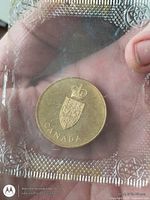 Obverse showing coat of arms and CANADA legend in sealed plastic