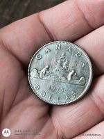 Reverse of 1975 Canadian dollar coin showing canoe design