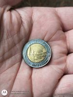 Reverse side displaying architectural scene, standing figure, braille dots, and value 500