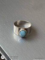 Front view of sterling silver band with larimar stone