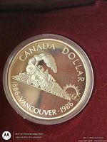 Reverse showing steam locomotive design and inscriptions CANADA DOLLAR 1886 VANCOUVER 1986