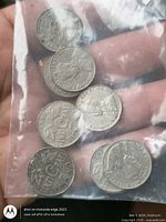 Seven Canadian 5-cent coins inside clear plastic bag, obverse and reverse visible