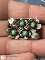 Front view showing floral design and turquoise cabochons