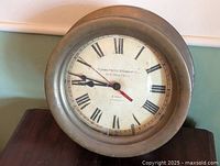 Front view of brass porthole clock showing dial details