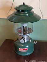Full view of Coleman 228F lantern showing vent, globe, tank, and handle