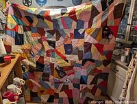 Full view of quilt hanging to show overall design and size