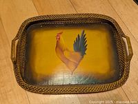 Top view of rectangular wood tray with wicker rim and rooster painting