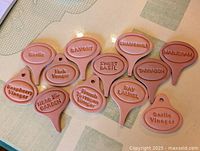 assortment of redware markers with embossed herb names