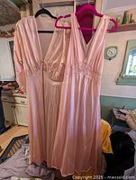 Nightgown and robe hanging together full length