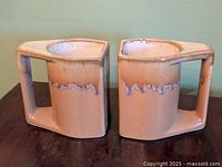 Front view of both angular ceramic mugs