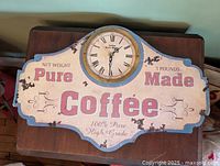 Front view of vintage-style coffee plaque wall clock showing overall design and clock face