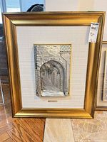 Full view of framed 3D metal relief artwork with MaxSold tag
