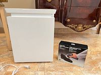 Levoit air purifier front view beside Voltage Valet shoe polisher box