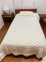 Top view of assembled twin bed with bedspread and pillow