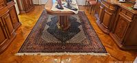 Full view of rug under dining table showing size and pattern