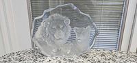 Front view of crystal sculpture showing lion family design