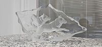 Front view of signed Mats Jonasson crystal sculpture showing two wolves