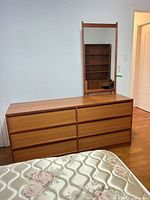 Front view of teak dresser with attached mirror