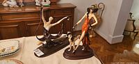 Both A. Santini resin figurines on table