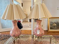 Front view showing both pink ceramic lamps with shades and bases
