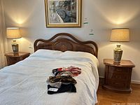 Both lamps on bedside tables flanking bed, shades visible