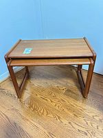 Pair of teak nesting tables stacked