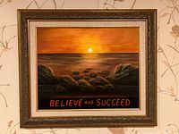 Front view of framed painting showing sunset scene and text