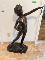Full front view of bronze boy sculpture