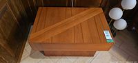 Top view of rectangular teak side table showing diagonal plank detail and finish