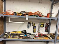 Two shelves with assorted hand tools, saws, wrenches, extension cords