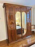 Front view of walnut veneer wardrobe with four doors, two central mirrors