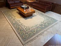 Full view of wool floral rug in room setting