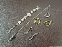 Overall view of bracelet, necklace, two pairs of earrings and ring