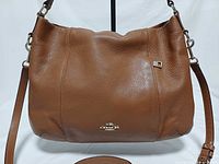 Front view of Coach Isabella brown leather handbag with strap