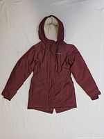 Front view of burgundy hooded jacket laid flat